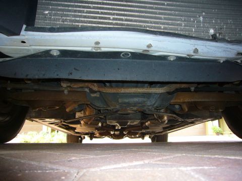 2001 Ford Crown Victoria - The underside of a vehicle is visible, revealing the exhaust pipes and suspension.