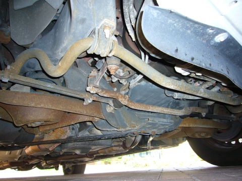 2001 Ford Crown Victoria - Undercarriage view of a vehicle's suspension and exhaust system.
