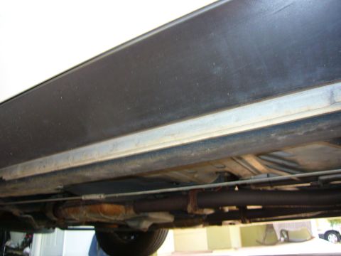 2001 Ford Crown Victoria - The underside of a vehicle, including exhaust components and a tire, is visible in this close-up shot.