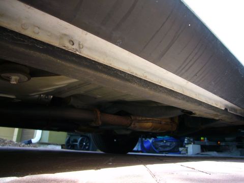 2001 Ford Crown Victoria - A low-angle shot captures the underside of a vehicle, revealing its exhaust system and chassis components.