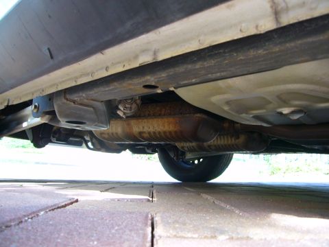 2001 Ford Crown Victoria - The underside of a vehicle is visible, with focus on the exhaust system and fuel tank.