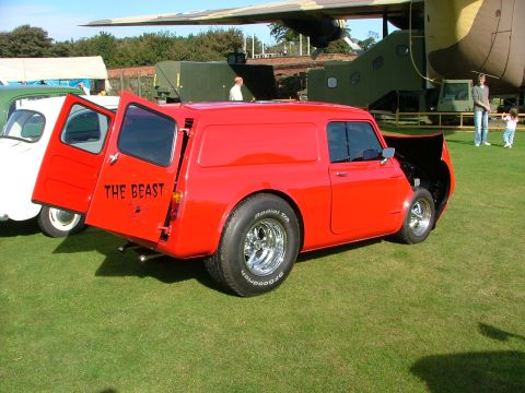 1988 Ford Sport - Red panel van with custom wheels and "THE BEAST" text on the rear door is displayed outdoors.