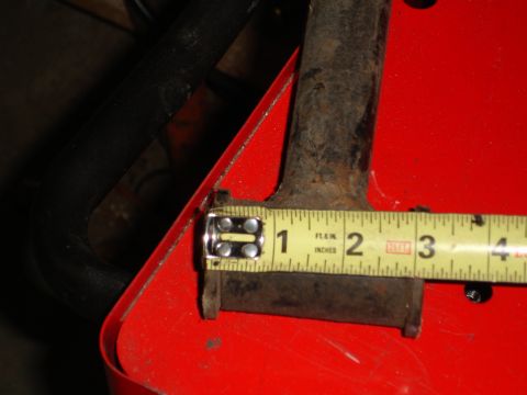 1989 Ford Bronco - A metal component is measured with a tape measure, indicating a length of about 1.5 inches.