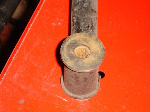 1989 Ford Bronco - A close-up view of a suspension component, likely a bushing, on a bright orange surface. The Supermotors.net watermark is present.