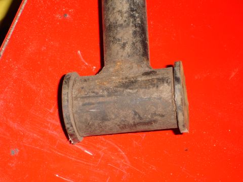 1989 Ford Bronco - A close-up view of a worn automotive part with visible rust and rubber components.