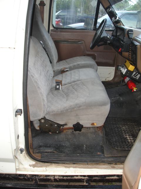 1989 Ford Bronco - Interior view of a white truck, showing the grey cloth seats and dashboard area.