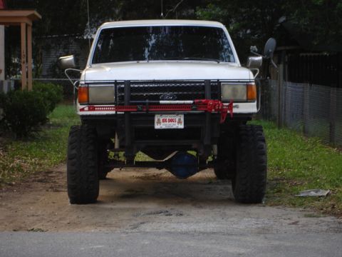 1989 Ford Bronco - This lifted 1989 Ford Bronco features aggressive off-road tires and a prominent front bumper with a Hi-Lift jack.