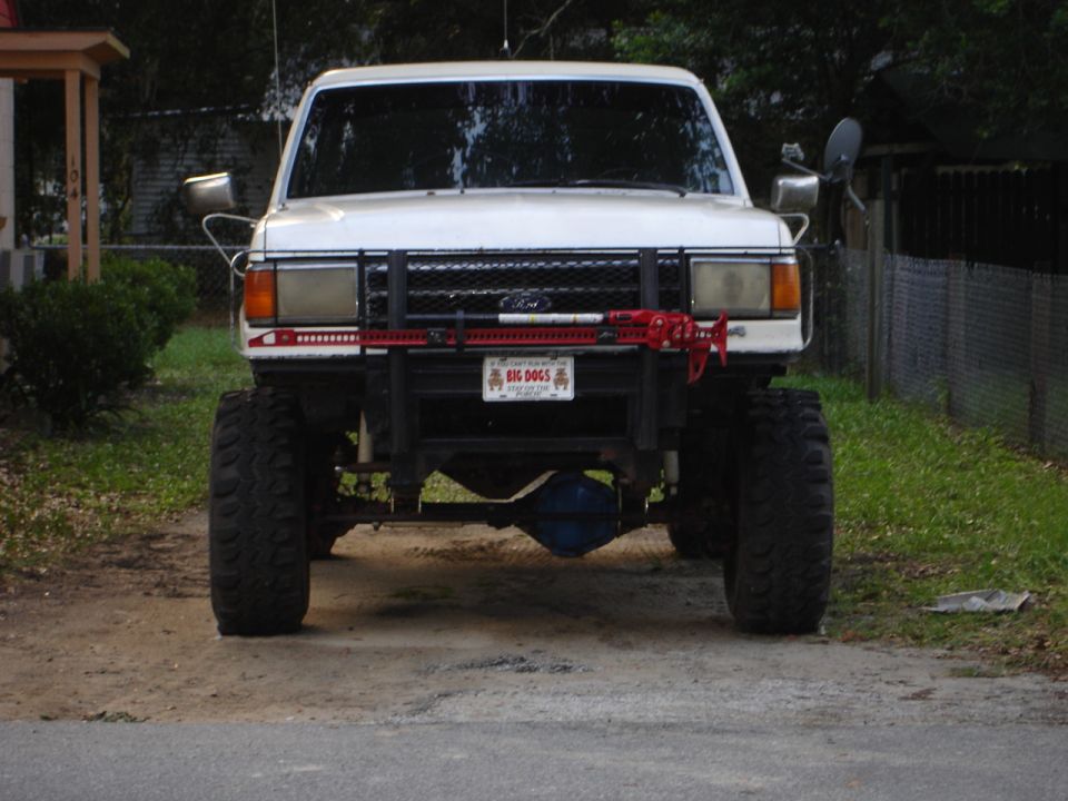 White 1989 Ford Bronco front view with lifted suspension and off-road tires