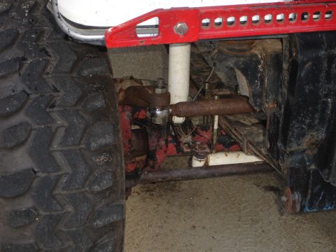 1989 Ford Bronco - Off-road vehicle front suspension detail with a Hi-Lift jack attached.