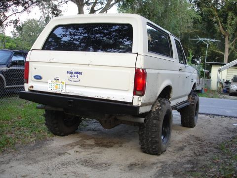 1989 Ford Bronco - This lifted Ford Bronco is shown from the rear, large off-road tires and a 'Blue Ridge 4x4' decal.