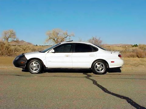 1999 Ford Taurus - This 1999 Ford Taurus is seen from the side, a black bra covering the front bumper.