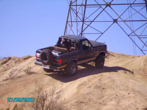 1990 Ford Bronco - This 1990 Ford Bronco navigates a sandy incline under a large power line tower.