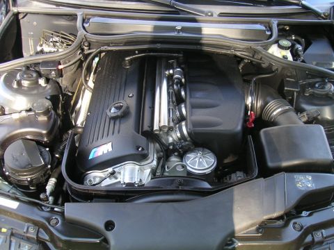 2002 BMW M3 - Engine bay view of a 2002 BMW M3, the prominent M logo on the valve cover.