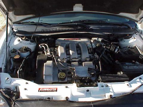 1999 Ford Taurus - The engine bay of a 1999 Ford Taurus is visible, showing the engine and various components.