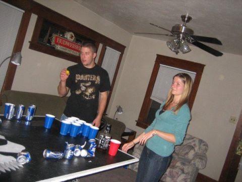 1996 Ford Bronco - Two people are gathered around a table set up for a game of beer pong.
