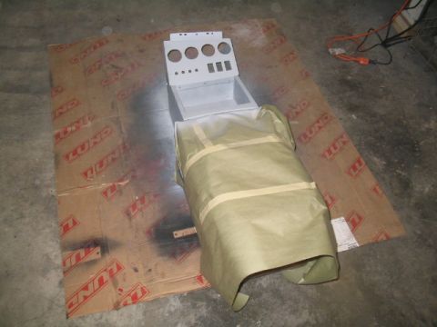1989 Ford Bronco - Center console part is being prepped for painting, covered in masking paper on a cardboard drop cloth.
