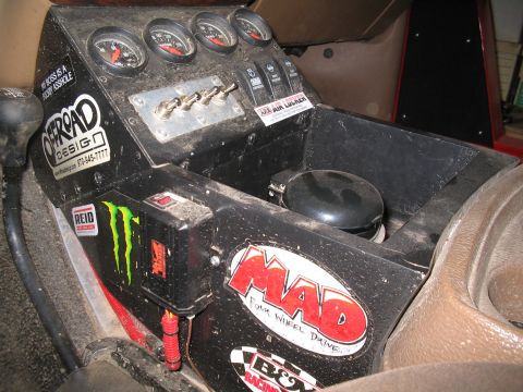 1989 Ford Bronco - The interior center console is covered in stickers and aftermarket gauges.