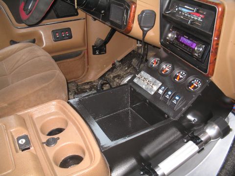 1989 Ford Bronco - Aftermarket stereo and gauges installed in the center console of a vehicle.