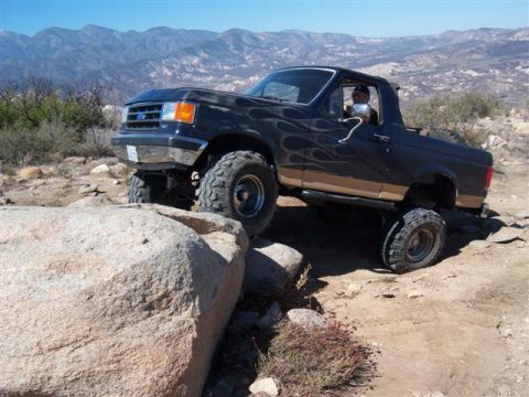 1995 Ford Bronco - Ford Bronco navigating rocky terrain off-road.