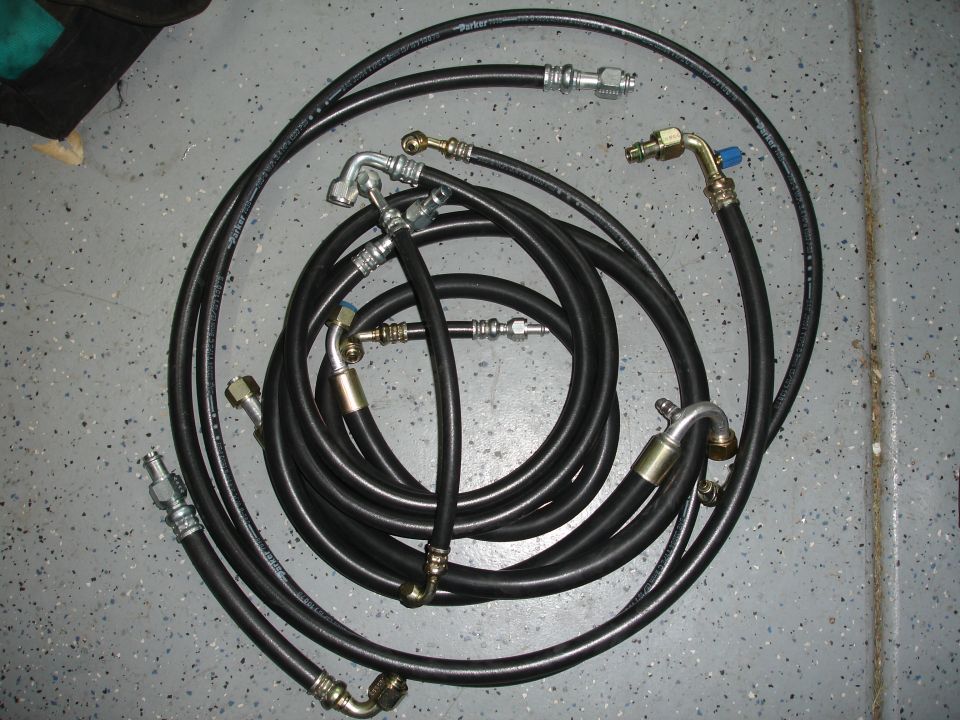 Set of black air conditioning hoses with various fittings