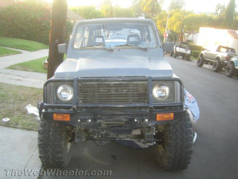1987 Suzuki Samurai - Front view of a 1987 Suzuki Samurai parked on a residential street.