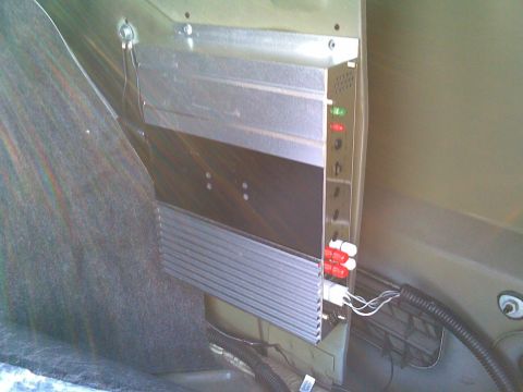 2003 Ford Crown Victoria - tucked in behind the trunk carpet and riveted in