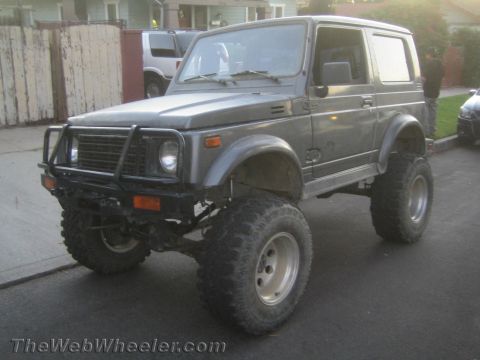 1987 Suzuki Samurai - Modified 1987 Suzuki Samurai features a lifted suspension and aggressive off-road tires.
