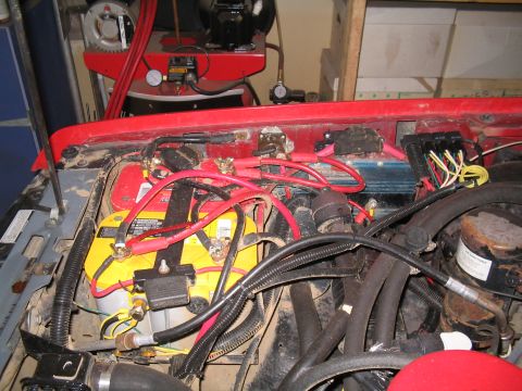 1989 Ford Bronco - The engine bay shows a dual battery system with an isolator, yellow Optima batteries and red wiring.