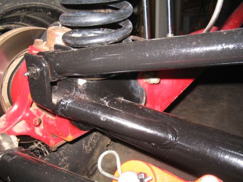 1989 Ford Bronco - Detail of vehicle's rear suspension system, showing control arms and coil spring.