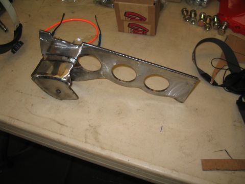 1989 Ford Bronco - A metal part, possibly a bracket for suspension components, is shown on a workbench.