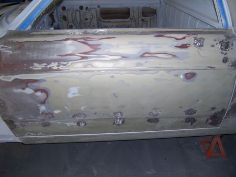 1967 Ford Ranchero - Car door in the process of body repair, with visible filler and primer.