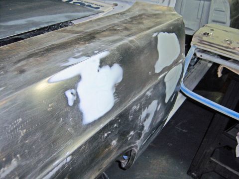 1967 Ford Ranchero - The rear quarter panel of a 1967 Ford Ranchero is shown with body filler applied, indicating ongoing restoration work.