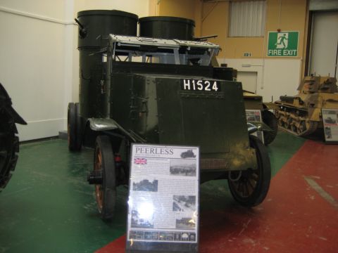 1966 Jeep CJ5 - An armored vehicle with large cylindrical turrets is displayed in a museum, with another tank visible in the background.