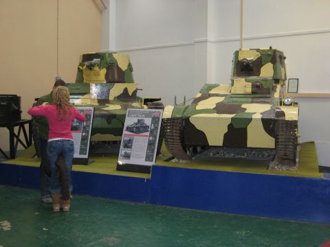 1966 Jeep CJ5 - Two military tanks are displayed in a museum setting with informational placards for visitors.
