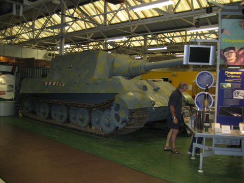 1966 Jeep CJ5 - A large tank destroyer with a long gun is on display in a museum, with informational exhibits around it.