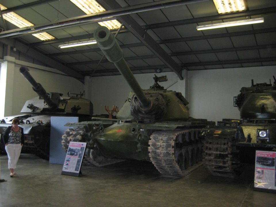 Tanks in a museum with display boards and a visitor