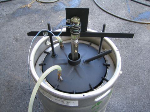 1985 Ford LTD Crown Victoria - A modified keg with a pump and plumbing system, likely for brewing or a similar process.