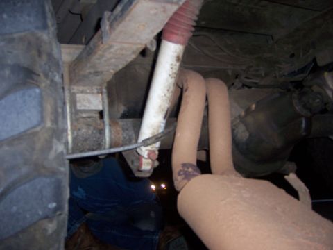 1991 Ford Bronco - Underside view of a vehicle's rear suspension and exhaust components.