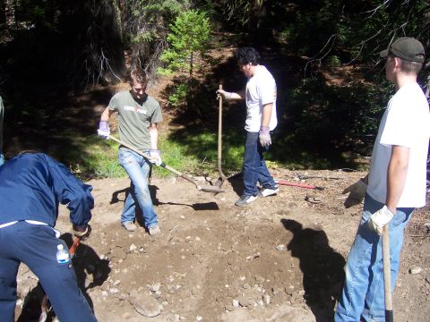 1991 Ford Bronco - People work with shovels in a wooded area.