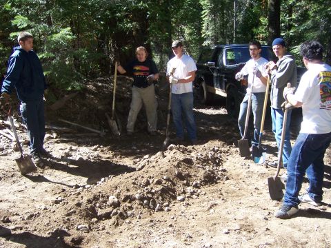 1991 Ford Bronco - A group of individuals are engaged in digging work outdoors, with a truck parked nearby.