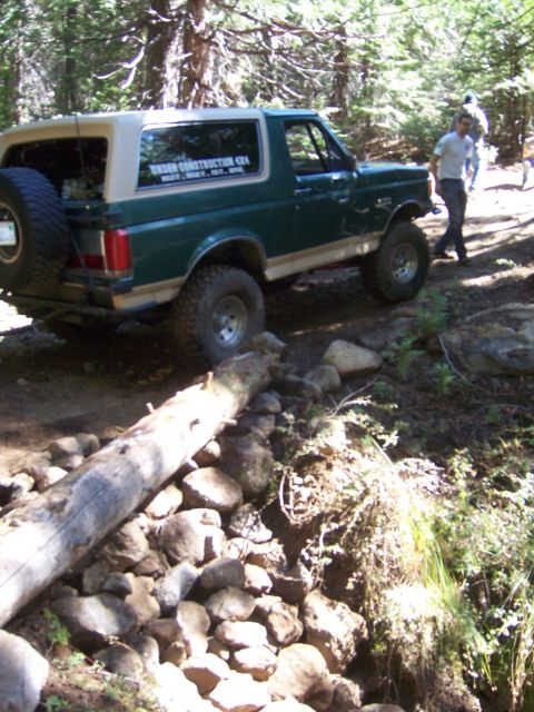 1991 Ford Bronco - Green 1991 Ford Bronco navigating an off-road obstacle course.
