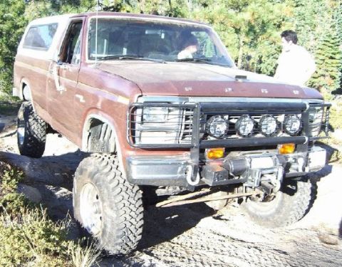 1989 Ford Bronco - This lifted Ford Bronco features a winch and auxiliary lights, suggesting it is used for off-road adventures.