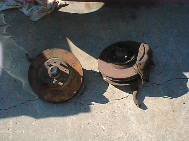 the new front brakes await! yup, those are kelsey hayes 4 piston units from a 66 tbird. they bolted right on now i am hoping the front end shop can align it (that will be a couple of weeks due to other mods that keep it from running)