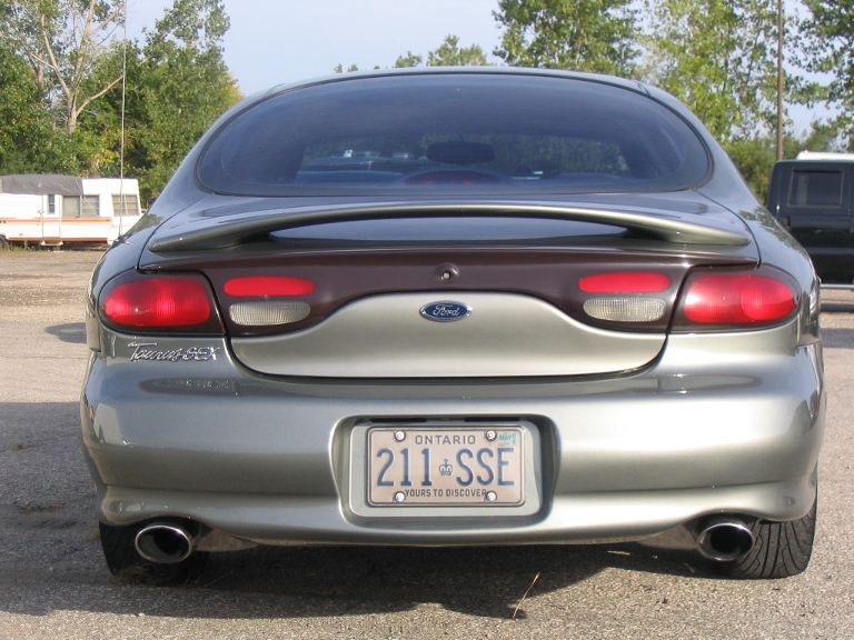 Rear view of a green Ford Taurus SHO sedan with Ontario plate 211 SSE