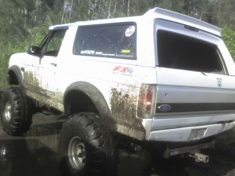 1995 Ford Bronco - Muddy 1995 Ford Bronco with lifted suspension and off-road tires.