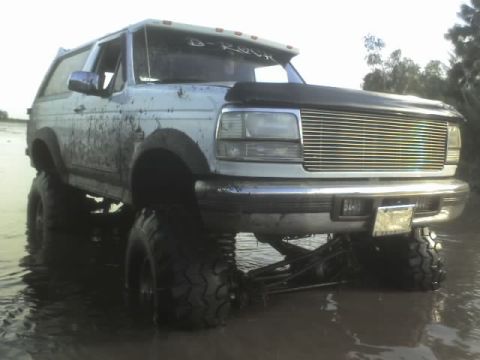 1995 Ford Bronco - This modified Ford Bronco is deep in the mud, its off-road capabilities.