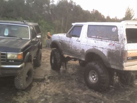 1995 Ford Bronco - Two Ford Broncos are stuck in the mud during an off-road adventure.
