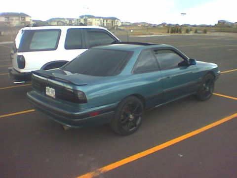 2001 Pontiac Trans Am - A teal coupe is parked in a lot, with a white SUV behind it.