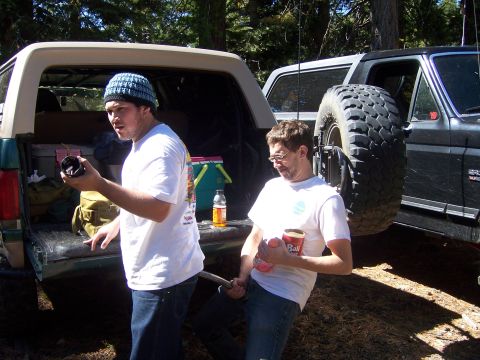 1991 Ford Bronco - Two men stand by a 1991 Ford Bronco and a Jeep Cherokee in a wooded area.
