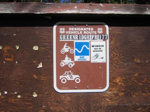 1987 Suzuki Samurai - A sign for a designated vehicle route shows icons for different types of vehicles and a note about winches.